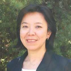 Dr. Ting-Ling Chang posing in an outside settings front of a tree.