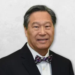 Dr. Chin is wearing a black blazer and bow tie