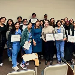 Group of people holding certificates