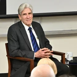 Julio Frenk, smiling and listening 