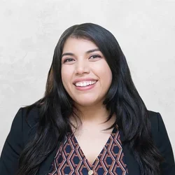 Esmeralda Garcia is wearing a black blazer over a patterned blouse.