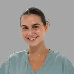 Dr. Brunswick is wearing medical scrubs.