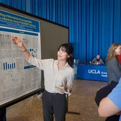 Researcher pointing at poster