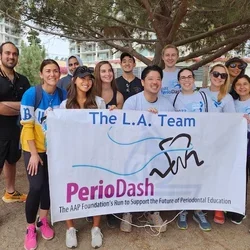 Runners in front of PerioDash Team LA sign