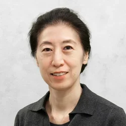 Dr. Jane Kwon is wearing a dark gray collared shirt.