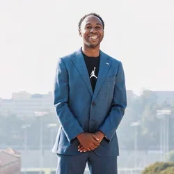 Martin Jarmond, standing with hands clasped, atop UCLA's Janss Steps