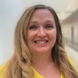 Dr. Jessica Owens, smiling in yellow shirt