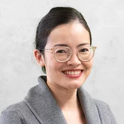 Dr. Vitzthum is wearing a black shirt with a gray button-down sweater coat.