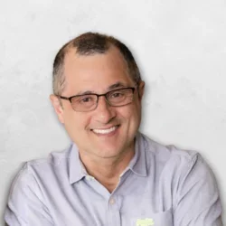 Luis Eduardo Martines is wearing a light blue shirt and has glasses.