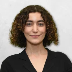 Lucy Samkian is wearing a black blouse and has medium length brown hair.