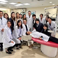 Group in lab coats, posing in a dental clinic
