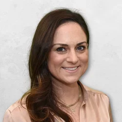 Dr. Kelman is wearing a button up blouse.