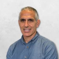 Michael A. Vourakis is wearing a light blue shirt.