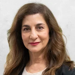 Dr. Mogharabi is wearing a sweater with black sweater coat.