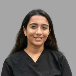 Tanya Kacker wearing black medical scrubs against a gray background