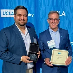 Dr. Mark Ortega and Dr. Paul Krebsbach pose against a blue backdrop