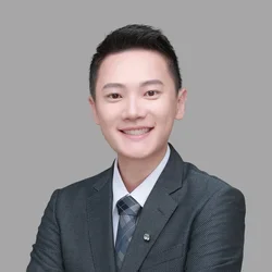 Huang Ting Lee in a dark-gray suit, against a light gray background