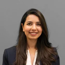 Dr. Samar Jalali is wearing a blazer over a white blouse.