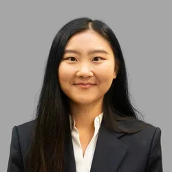 Dr. Qianlin (Leah) Ye is wearing a black blazer over a white blouse.