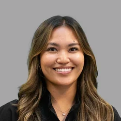 Dr. Jessica Fukushima is dressed in black medical scrubs.