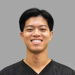 Dr. Justin Thamsorn is dressed in black medical scrubs.