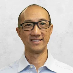 Dr. Chamkasem is wearing a light blue collar shirt.