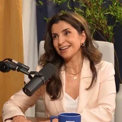 Rana Al Rasheed sitting in front of mic, smiling