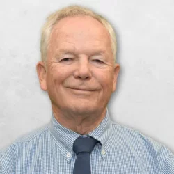 Dr. Duell is wearing a shirt and tie.