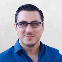 Dr. Boyer is wearing glasses and blue collared shirt.