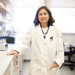 Yvonne Hernandez-Kapila, in a white lab coat