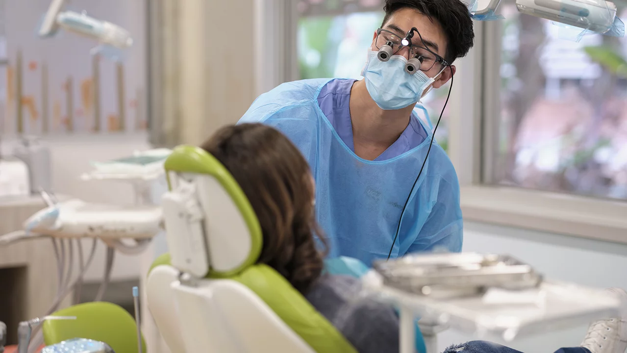 A pediatric resident with a patient.