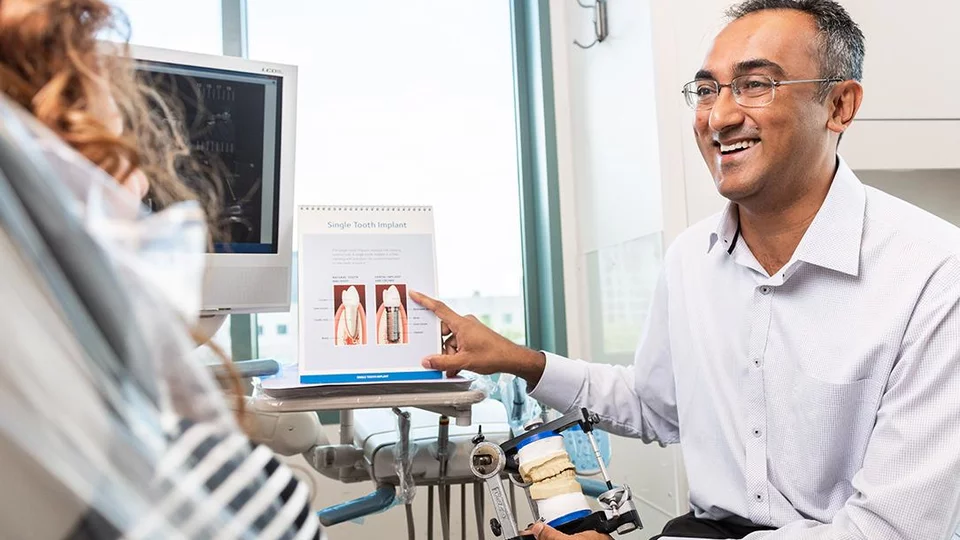 Dr. Shah with a patient in the Faculty Group Dental Practice.