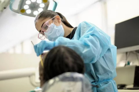 A UCLA dental student treating a patient.