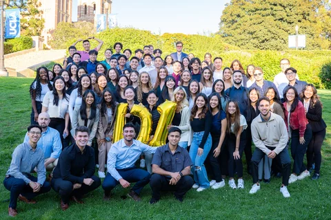 88 people posing on grass