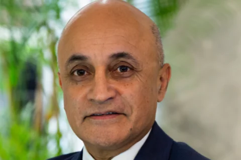 Dr. Kapila in suit and tie headshot