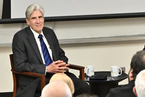 Julio Frenk, smiling and listening
