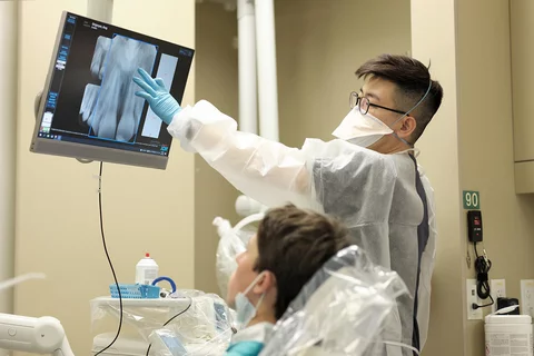 An endodontics resident with a patient.