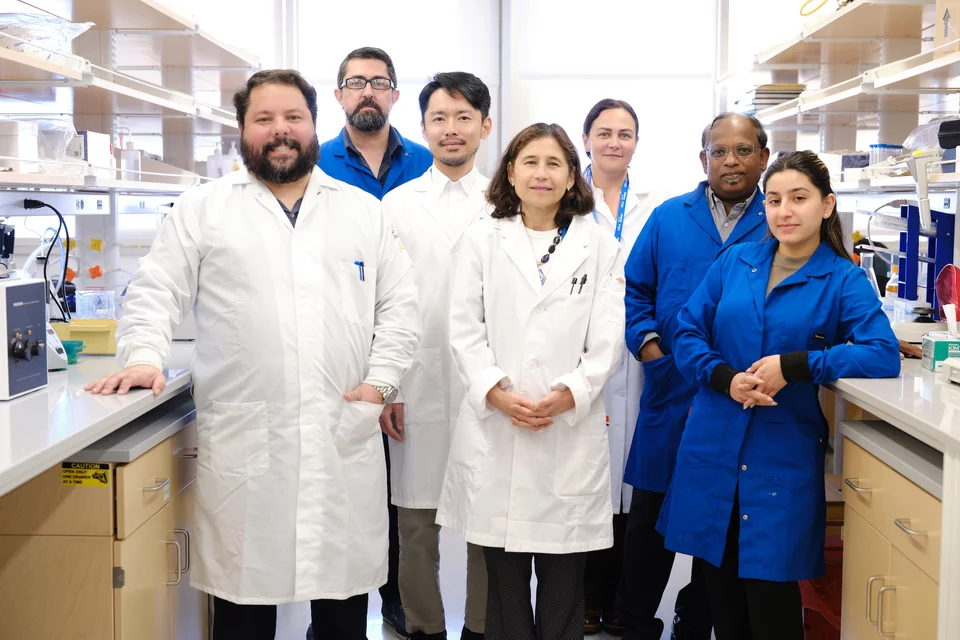 Seven people in lab coats