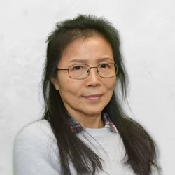 Chungyu Chang has long dark hair and is wearing glasses