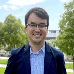 Dr. Davi Silva wearing a navy blazer and light blue shirt