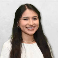Headshot of Juliana Martinez Hernandez. Juliana Martinez Hernandez has long hair and is wearing a white top