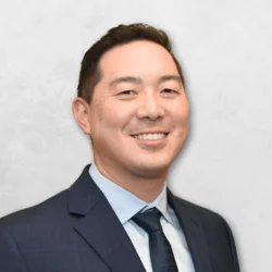 Dr. Marc Hayashi is wearing a suit