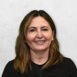 Dr. Parsangi is wearing a black top and has medium-length brown hair