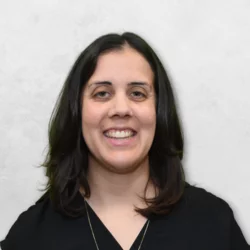 Nicole Crosgrove is wearing a black top and has medium-length black hair.
