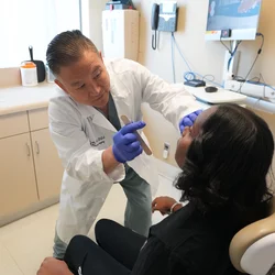 dr. wayne ozaki examining a patient